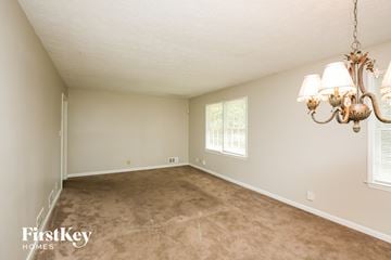 Lawrenceville house for rent - a living room with a carpet and a chandelier