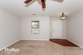 Odenville house for rent - A room with a ceiling fan and a window with blinds.