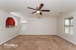 Odenville house for rent - A room with a ceiling fan and carpeted floor.