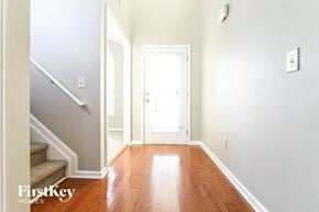 Lawrenceville house for rent - a entryway with stairs and a door to a hallway with hardwood flooring
