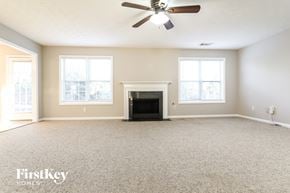 Lawrenceville house for rent - a living room with a fireplace and a ceiling fan
