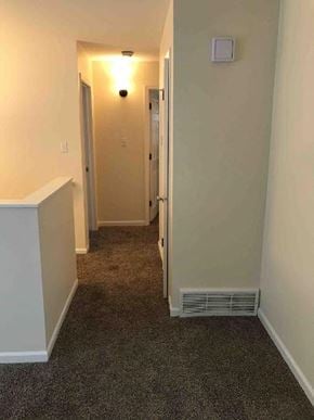 Glenwood house for rent - a hallway with a carpeted floor and white walls