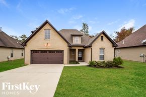 Wilsonville house for rent - a tan brick house with a brown garage door