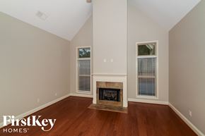 Wilsonville house for rent - a living room with wood flooring and a fireplace