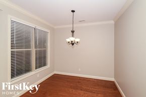 Wilsonville house for rent - a empty dining room with a large window and a chandelier