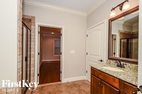 Wilsonville house for rent - a bathroom with a sink and a mirror and a hallway to a bedroom