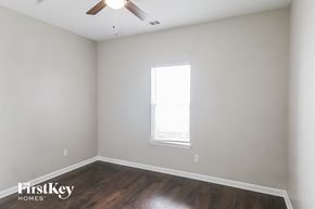 Newnan house for rent - a bedroom with white walls and wood floors and a window