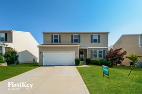 O'fallon house for rent - a house with a garage door and a lawn