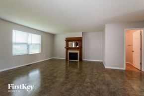O'fallon house for rent - an empty living room with a fireplace and a window
