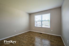 O'fallon house for rent - a empty room with a window and a tiled floor