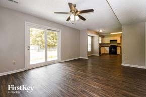 Summerville house for rent - A spacious room with a ceiling fan and wooden flooring.
