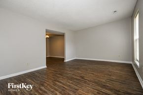 Summerville house for rent - A room with wooden flooring and a doorway leading to another room.