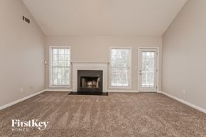 Mcdonough house for rent - the living room has a fireplace and carpeted flooring