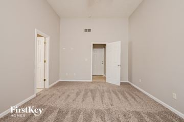 Mcdonough house for rent - a spacious living room with carpet and white doors