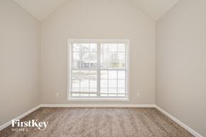 Mcdonough house for rent - a bedroom with a large window and carpet