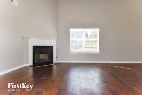 Covington house for rent - A room with a fireplace and a window.