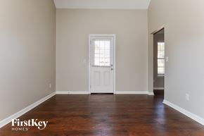 Covington house for rent - A room with a white door and wooden floor.