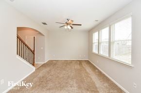 Hiram house for rent - A spacious room with a carpeted floor and a ceiling fan.