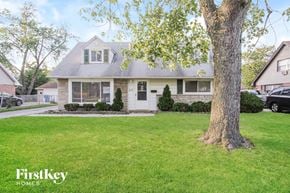 Chicago Heights house for rent - a white house with a tree in the front yard