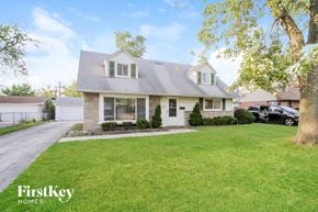 Chicago Heights house for rent - a home with a lawn and a car parked in front of it