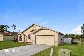 Winter Haven house for rent - a beige house with a garage and a driveway