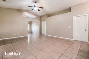Winter Haven house for rent - the spacious living room with tile flooring and a ceiling fan