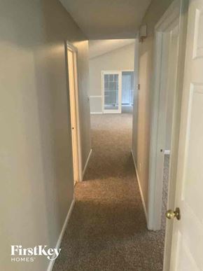 Locust Grove house for rent - a hallway with a carpeted floor and a door to a bedroom