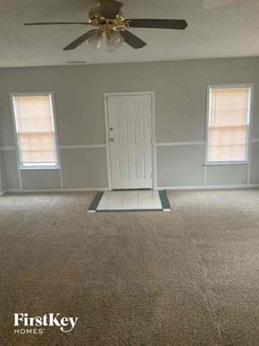 Locust Grove house for rent - an empty room with a white door and a ceiling fan