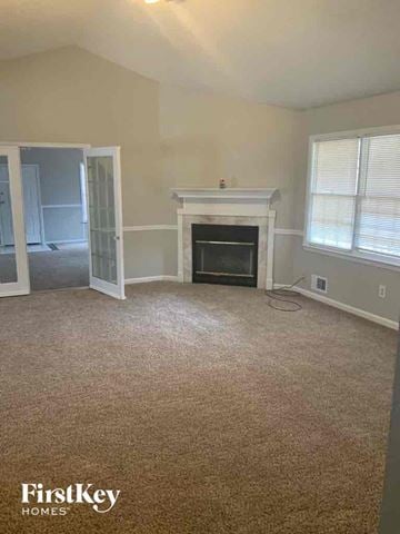 Locust Grove house for rent - a living room with a carpeted floor and a fireplace