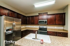 Dallas house for rent - a kitchen with stainless steel appliances and granite counter tops