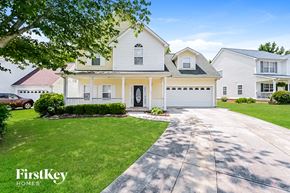 Newnan house for rent - A white house with a garage is shown in the image.