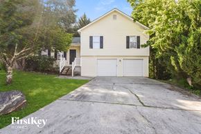 Stockbridge house for rent - a white house with a white garage with a driveway