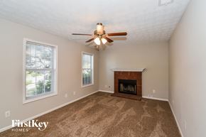Stockbridge house for rent - the living room has a fireplace and a ceiling fan