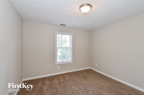 Stockbridge house for rent - a bedroom with a carpeted floor and a window