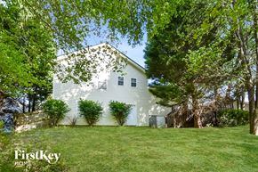 Stockbridge house for rent - a white house with a green lawn and trees
