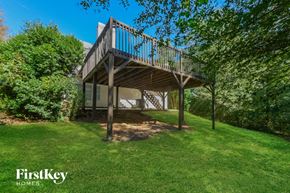 Braselton house for rent - a house with a deck on top of a grass yard