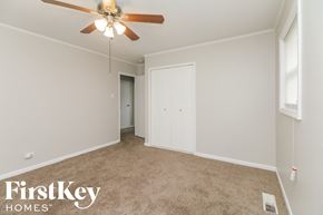 Park Forest house for rent - a living room with a ceiling fan and a door to a closet