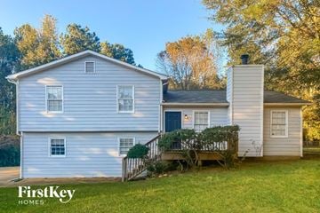 Newnan house for rent - a white house with a deck and a blue door