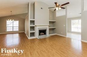 Alabaster house for rent - A spacious living room with a fireplace and built-in shelves.