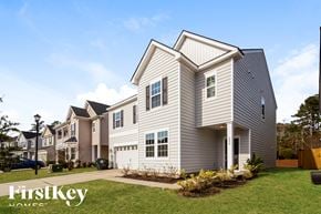 Moncks Corner house for rent - A house with the words "FirstKey Homes" on the front lawn.