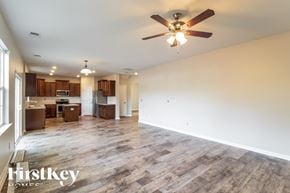 Moncks Corner house for rent - A spacious living room with a wood floor and a ceiling fan.