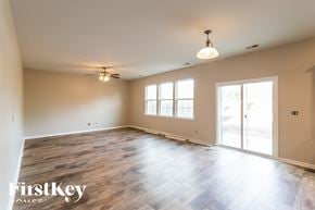 Moncks Corner house for rent - A spacious room with wooden flooring and a ceiling fan.