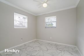 Lehigh Acres house for rent - a bedroom with white marble floors and two windows