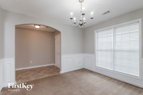 Winder house for rent - a dining room with a large window and a chandelier