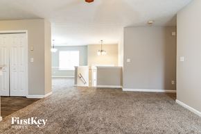 Winder house for rent - an empty living room with carpet and a kitchen