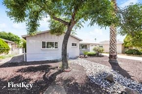 Phoenix house for rent - a white house with trees and rocks in front of it