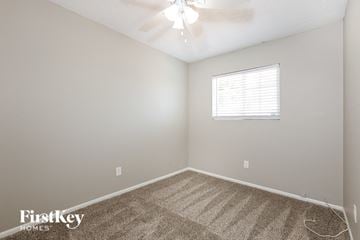 Phoenix house for rent - the living room of a home with carpet and a ceiling fan