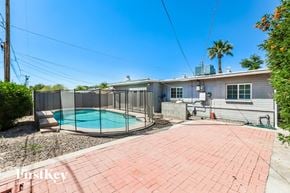 Phoenix house for rent - a backyard with a pool and a house with a fence
