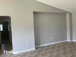 Cape Coral house for rent - an empty living room with a tiled floor