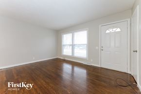 Belton house for rent - A room with wooden floors and a white door.
